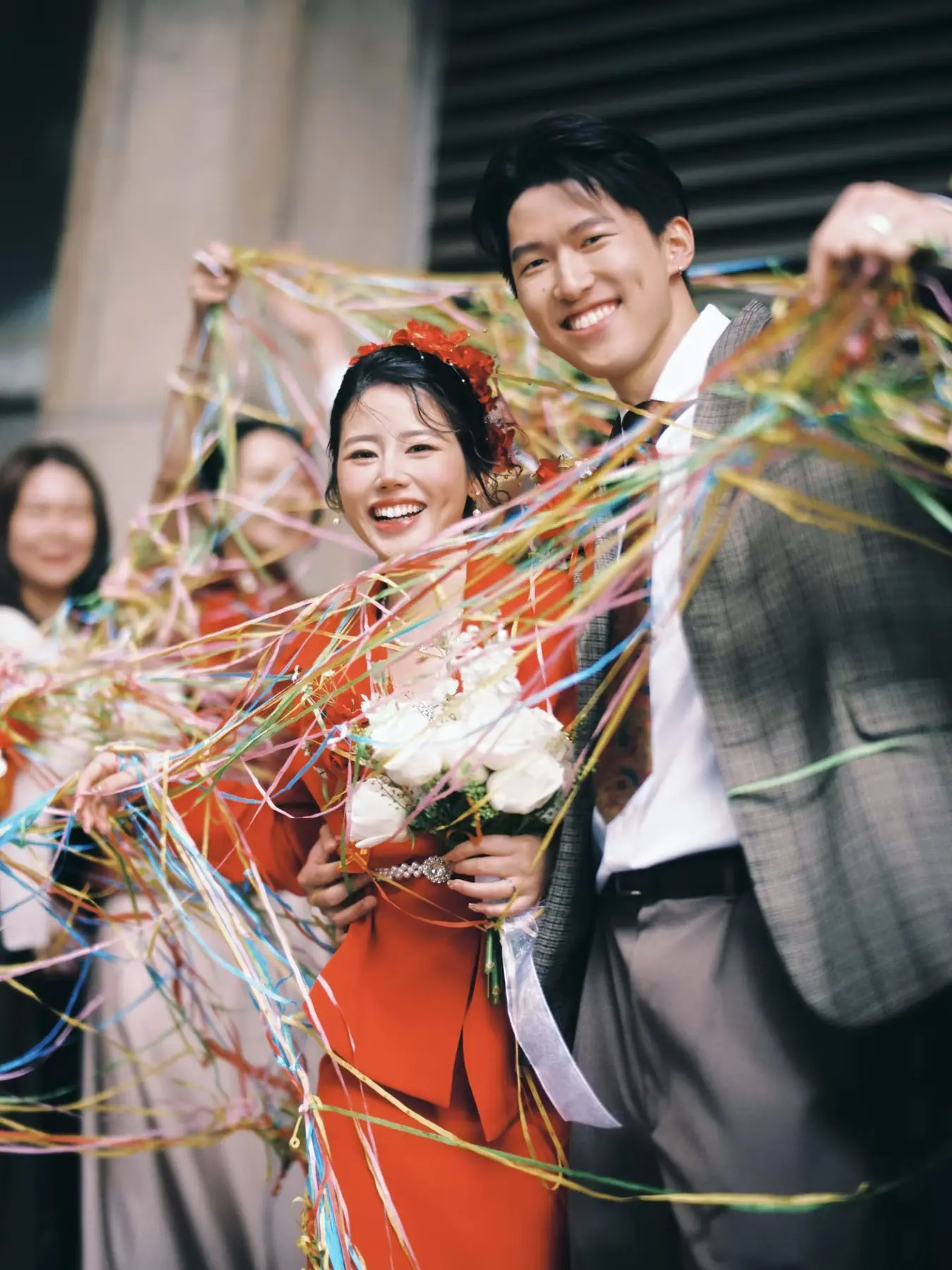 Newlyweds celebrating with colourful ribbons