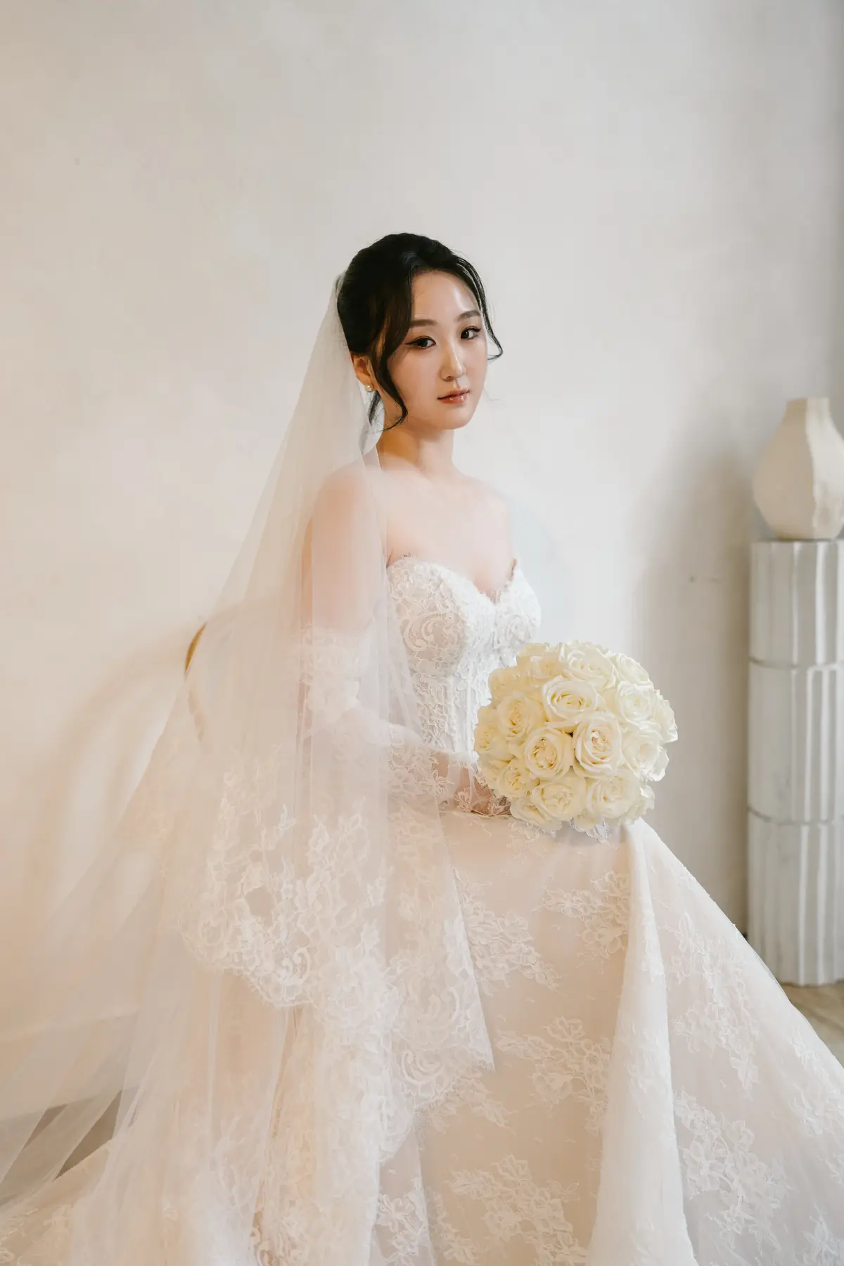 Bride in a sculptural lace gown by Angelina