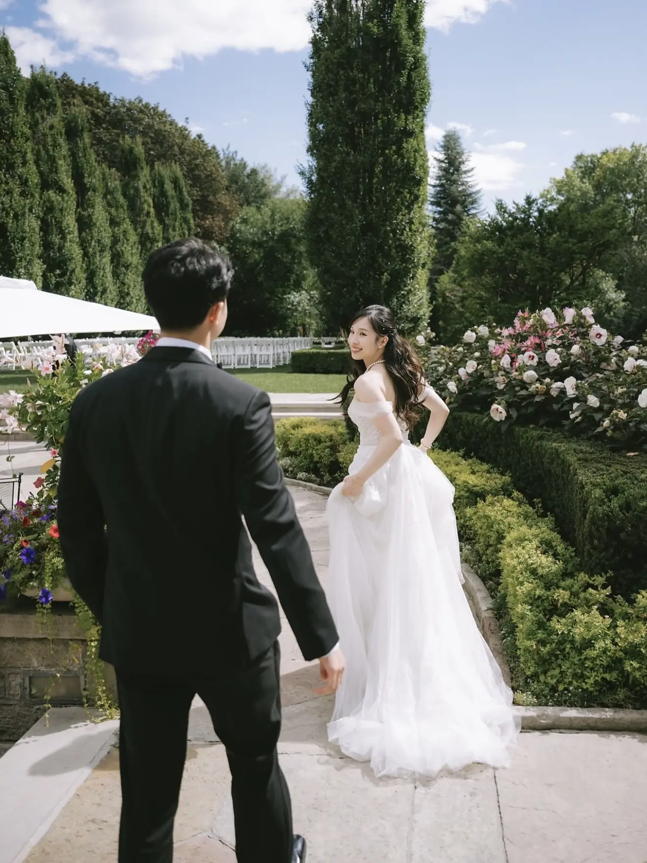 Newlyweds walking through a garden venue