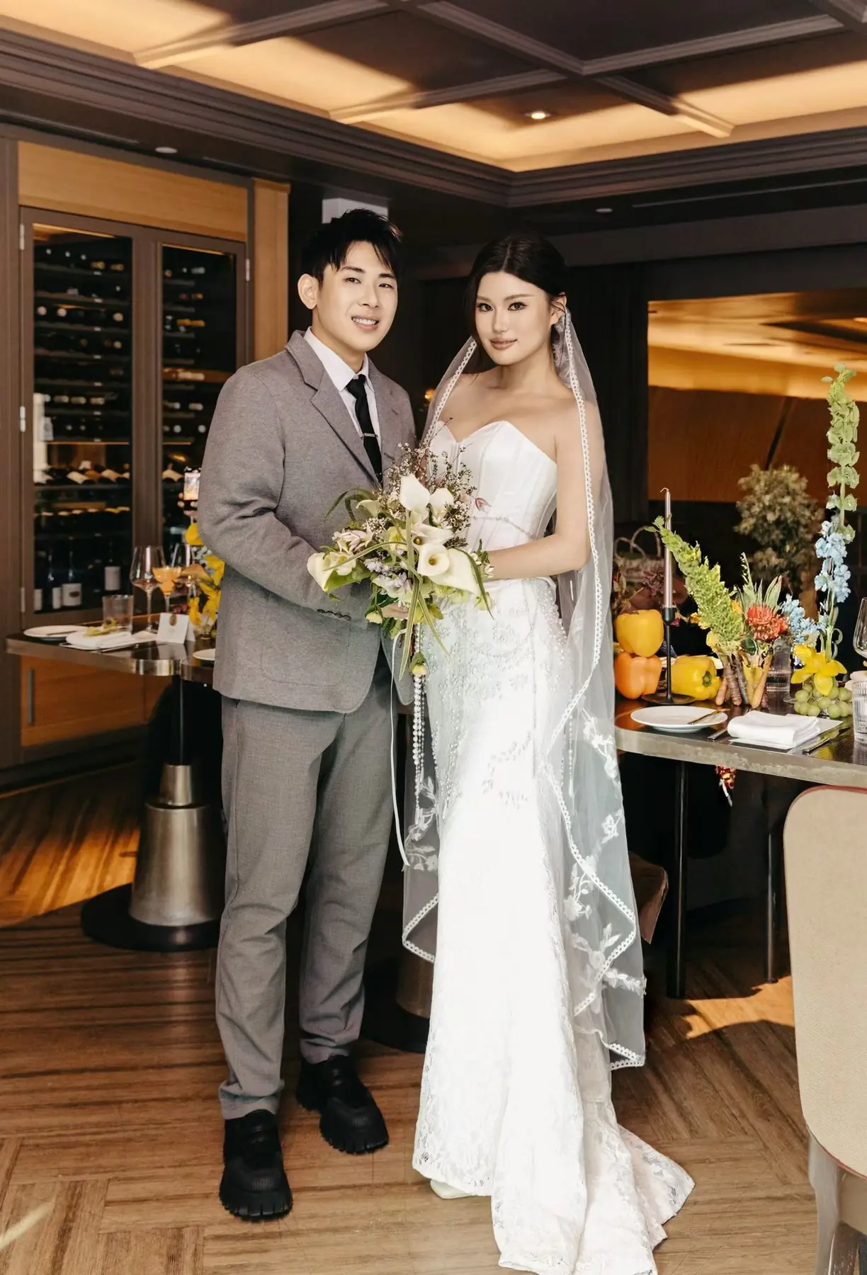 Full-length indoor portrait of newlyweds