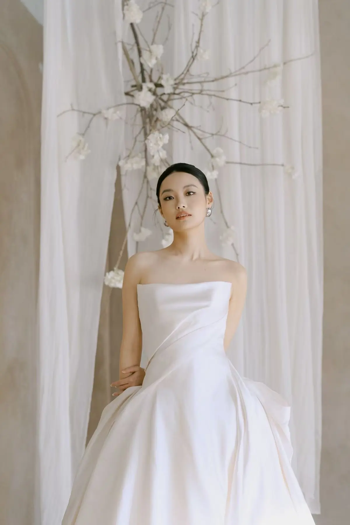 Minimal bridal portrait in a sculptural white gown