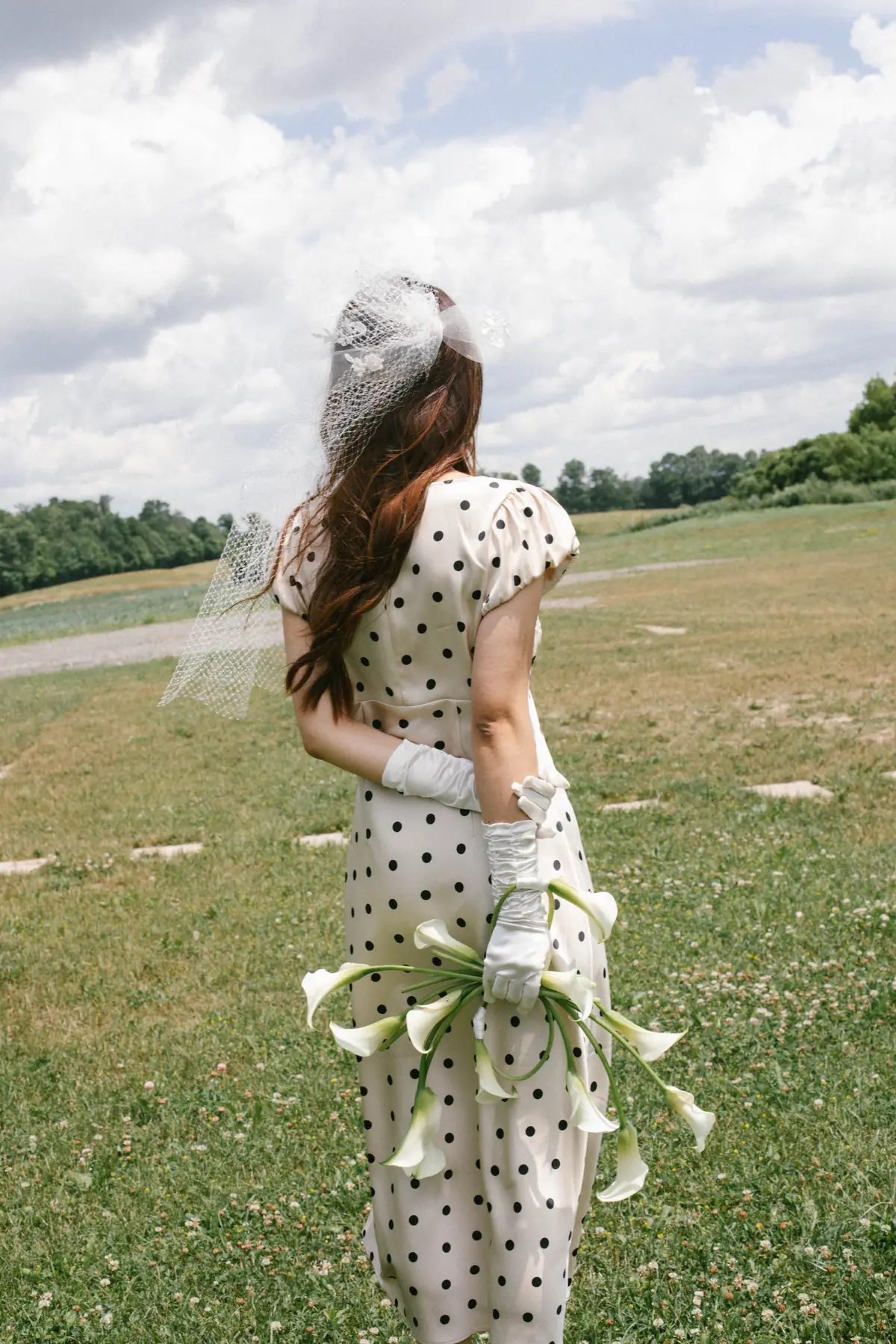 Polka-dot bridal portrait in an open field