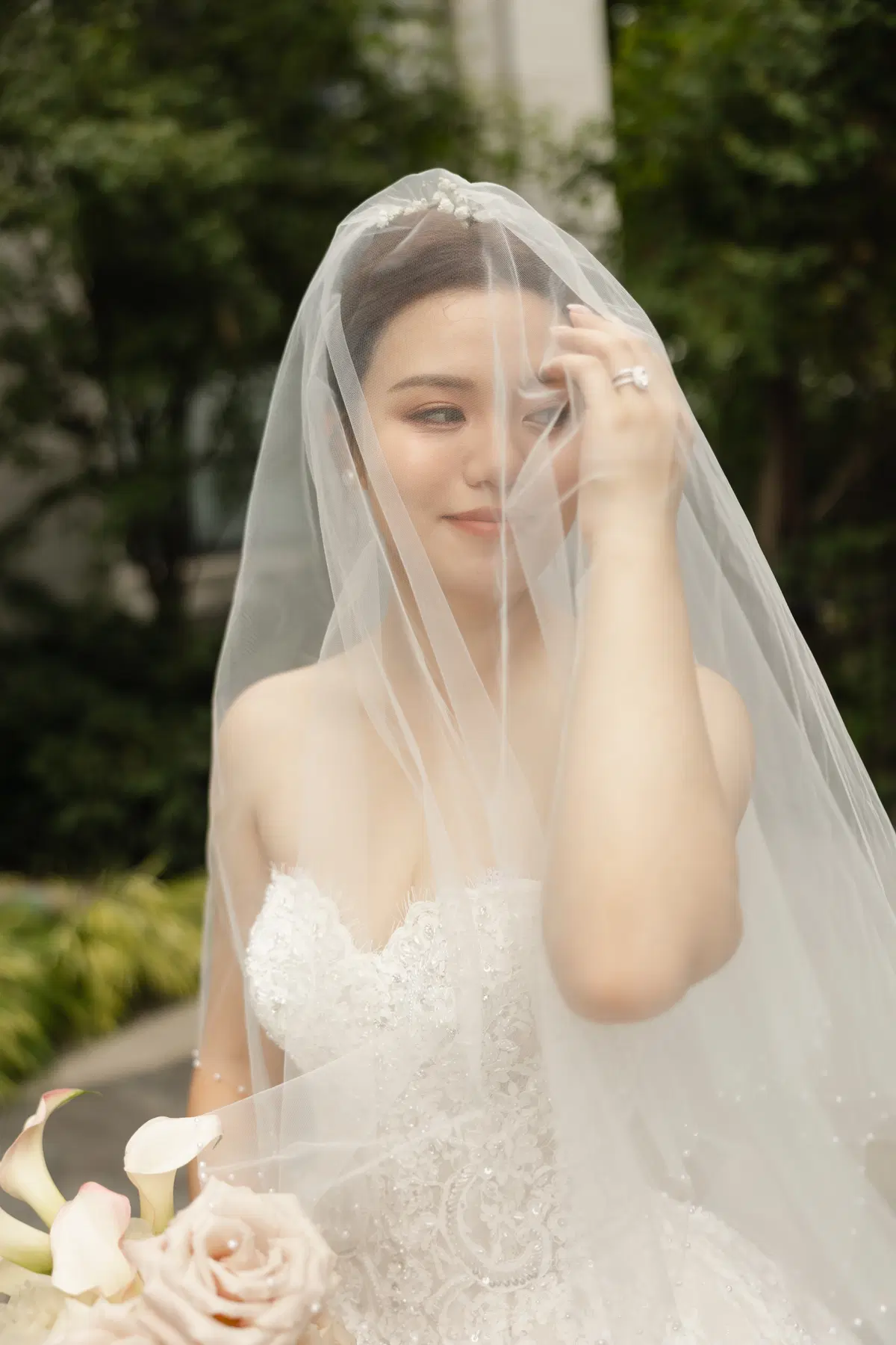 Outdoor bridal beauty beneath a soft veil