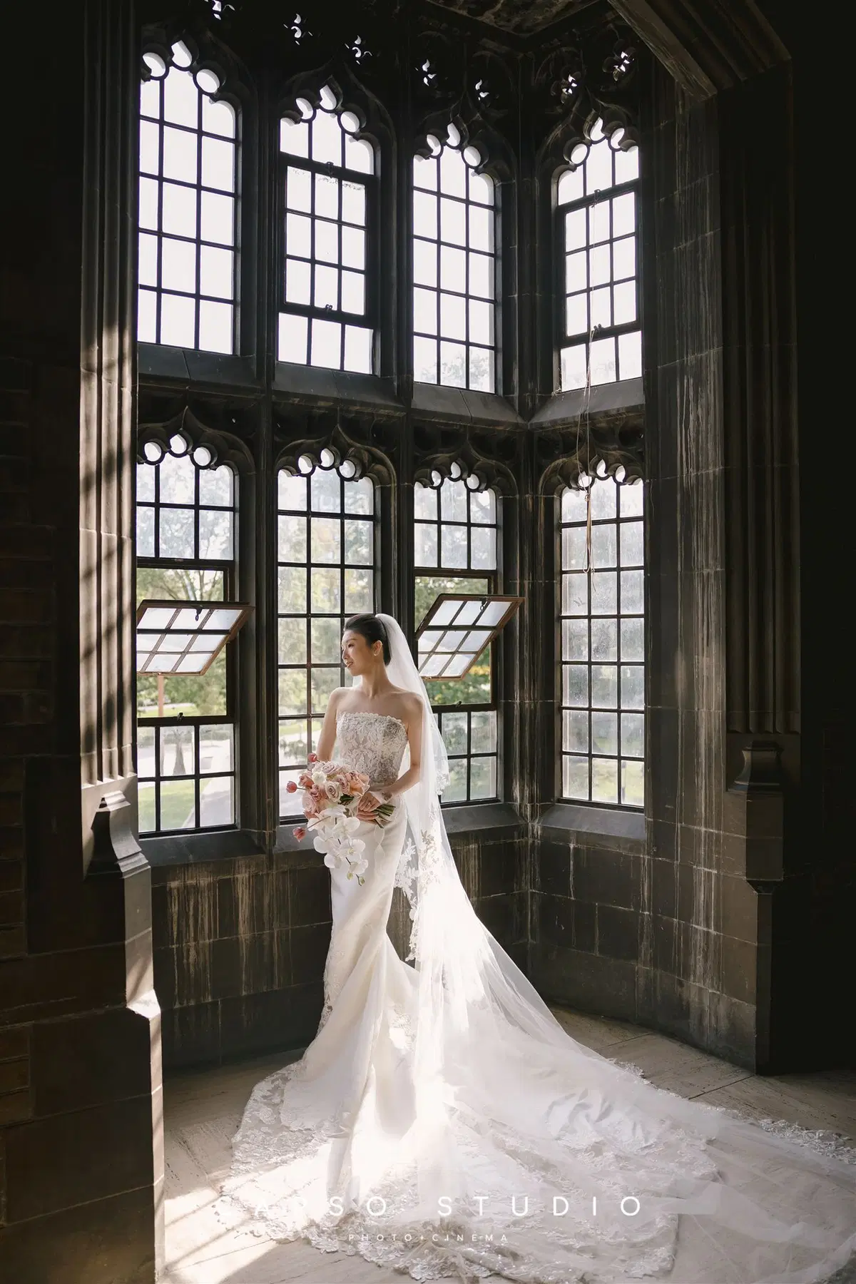 Full-length bridal portrait in an arched window