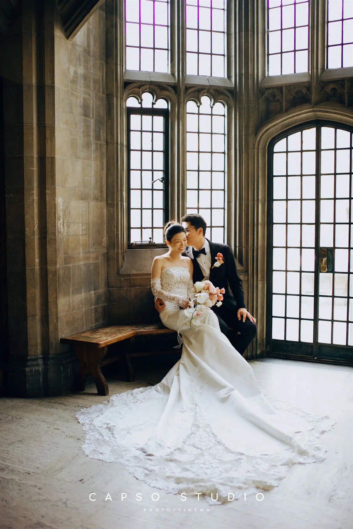 Wedding couple framed by a gothic window