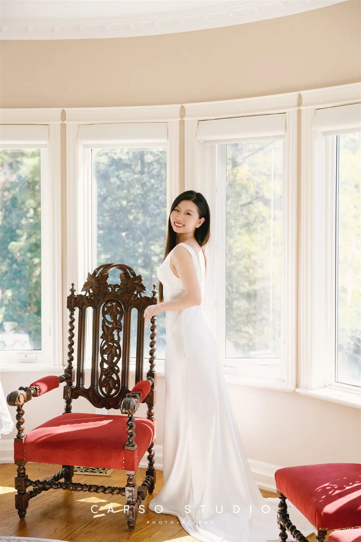 Bride in a sunlit bay window