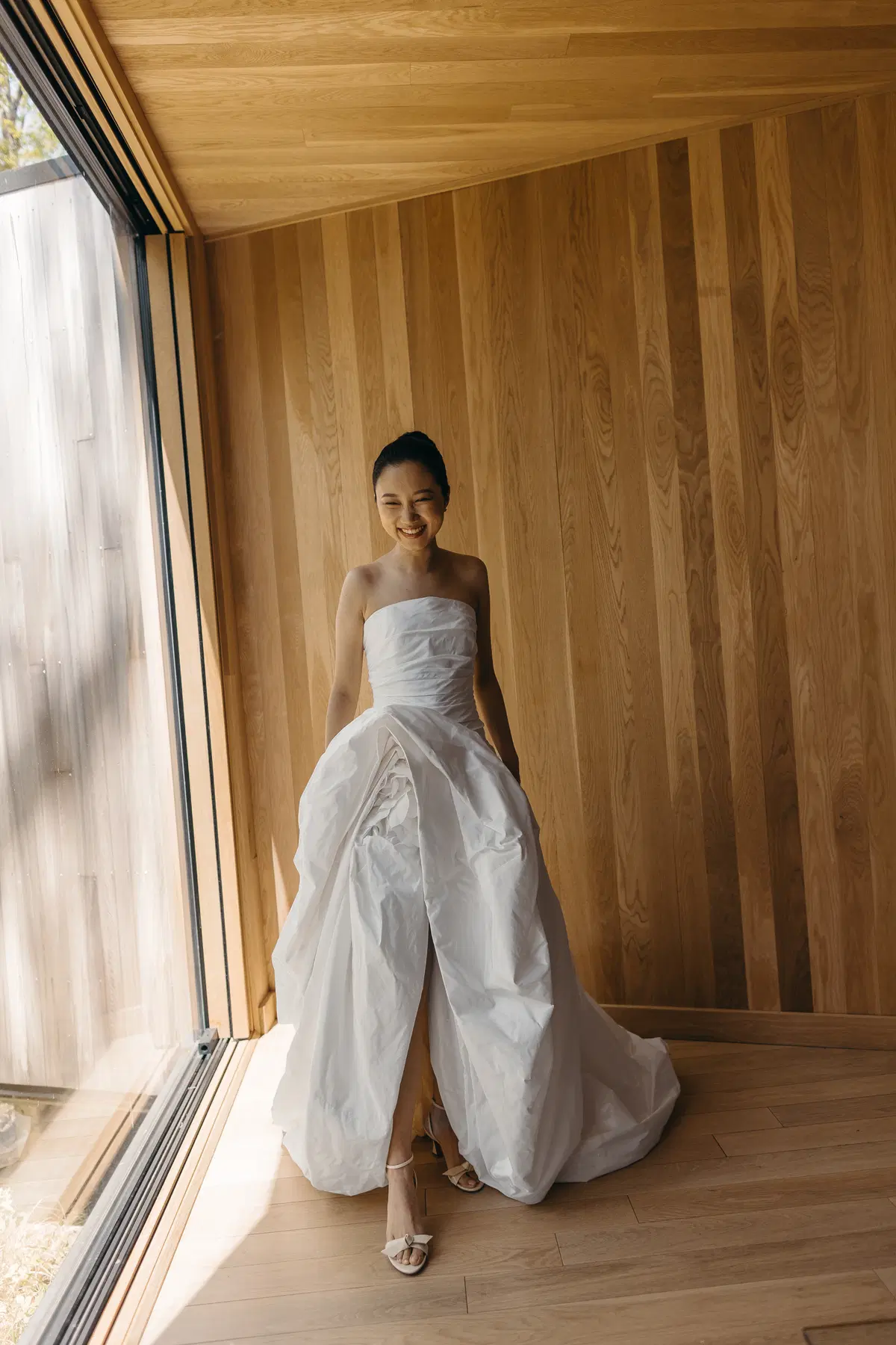 Architectural bridal portrait by a wooden window