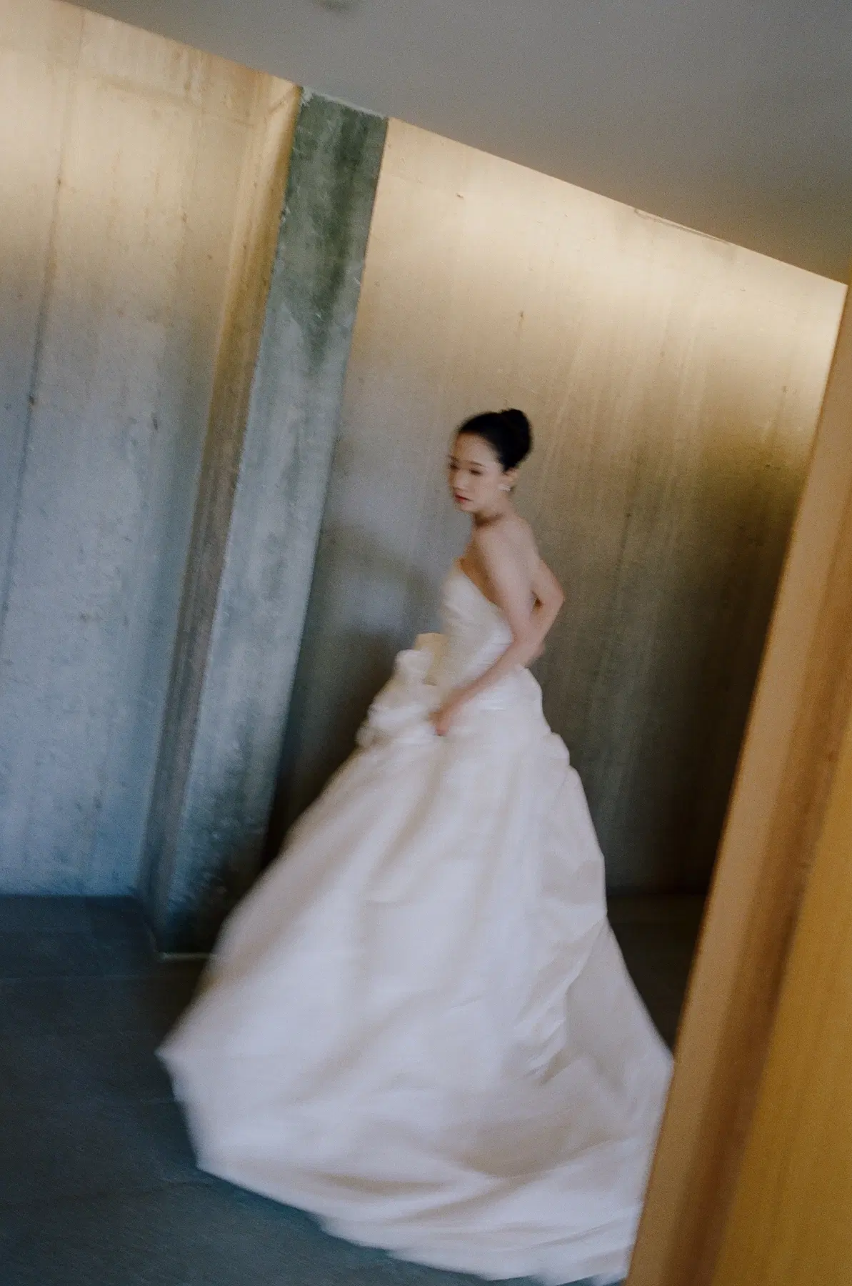 Modern bridal portrait in a sculptural corridor