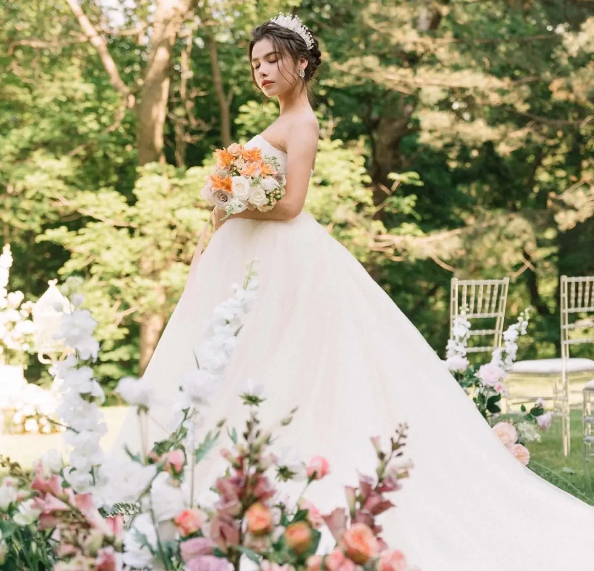 Bride among garden florals in a blush gown