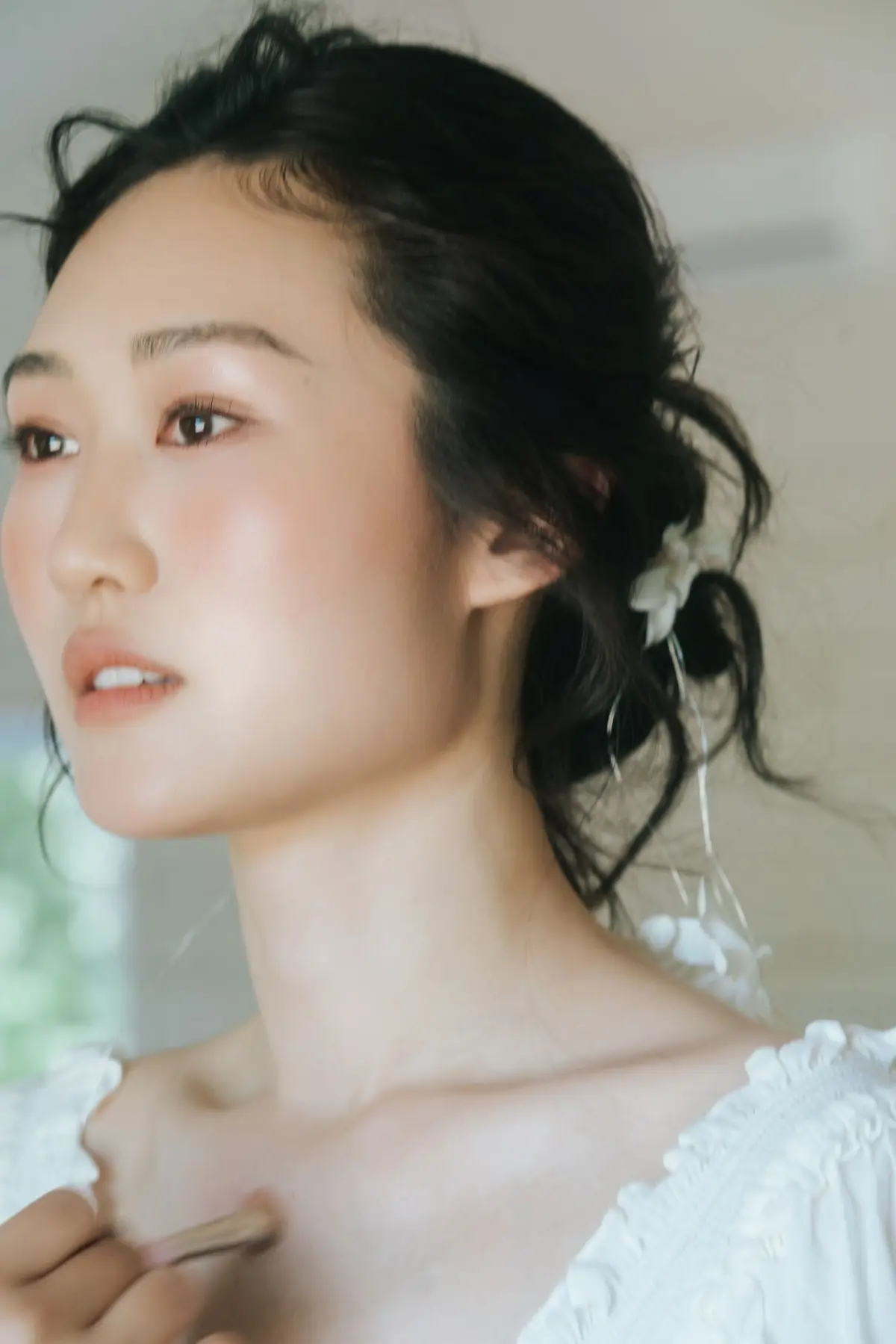 Soft bridal makeup and textured updo portrait