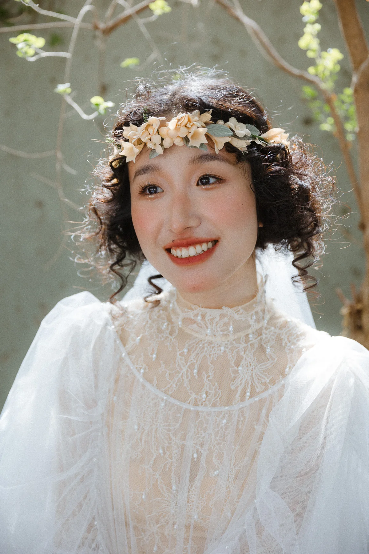 Smiling bride in a floral headpiece